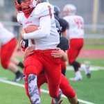 Photo by Kelly Sullivan/ Peninsula Clarion Kenai Kardinals' Kyle Foree tackles Wasilla Warriors' Zach Garnett, Friday, September 12, 2014 at Kenai Central High School in Kenai, Alaska.