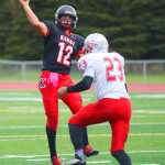 Photo by Kelly Sullivan/ Peninsula Clarion Kenai Kardinals' Jace Baker makes a quick pass before Wasilla Warriors' DJ Morrow can tackel the ball from him, Friday, September 12, 2014 at Kenai Central High School in Kenai, Alaska.