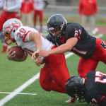 Photo by Kelly Sullivan/ Peninsula Clarion Kenai Kardinals' Kyle Hunter tackeles Wasilla Warriors' Devin Otto, Friday, September 12, 2014 at Kenai Central High School in Kenai, Alaska.