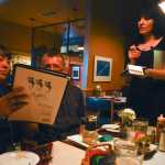 Photo by Rashah McChesney/Peninsula Clarion Margarita Panchenko, of Kamchatka, helpsViktor Zoloutkhin, of Kamchatka, order during dinner at Mykels Wednesday Sept. 10, 2014 in Soldotna, Alaska.