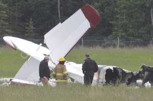 Photo by Rashah McChesney/Peninsula Clarion  Investigators look at the remains of a fixed-wing aircraft that was engulfed in flames Sunday July 7, 2013 at the Soldotna Airport in Soldotna, Alaska. No survivors were located and it is unknown how many people were on board.
