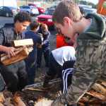 Photo by Kelly Sullivan/ Peninsula Clarion Sage Hill, a Life Scout in Boy Scouts of America Troop 151 and junior at Soldotna High School, built a perpetual wood shelter at the Kenai Peninsula Food Bank for residents and locals in need of firewood to heat their homes this winter. Members of Hill's troop and the Church of Jesus Christ of Latter Day Saints in Soldotna helped pile in the first stacks of wood taken from Soldotna City Manager Mark Dixson's property, Saturday, September 20. 2014 in Soldotna Alaska.