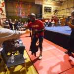 Photo by Kelly Sullivan/ Peninsula Clarion New Frontier Wrestling Alliance Champion Calvin James enters the arena and greets his fans, Saturday, September 20, 2014 during the Kardinals Wrestling Team Fundraiser presented by Power Plant Productions at Kenai Central High School in Kenai, Alaska.