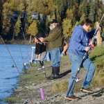 Photo by Rashah McChesney/Peninsula Clarion Silver salmon anglers line the banks of the Kenai River Tuesday September 23, 2014 in Soldotna, Alaska.