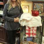 Jeanie Carter stands near an antique trunk in her store, Ye Olde Curiosity Shoppe, in Kenai on Monday. Carter opened the vintage boutique in July. Photo by Kaylee Osowski/Peninsula Clarion
