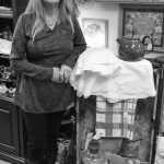 Jeanie Carter stands near an antique trunk in her store, Ye Olde Curiosity Shoppe, in Kenai on Monday. Carter opened the vintage boutique in July. Photo by Kaylee Osowski/Peninsula Clarion