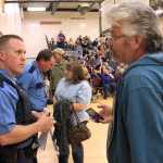 Photo by Dan Balmer/Peninsula Clarion Nikiski resident Dennis Barnett shares information with Alaska State Trooper Matt Ezell at a town hall meeting at the Nikiski Recreation Center Wednesday. Residents gathered to search for answers to a rash of thefts that has affected the community.
