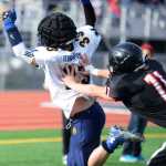 Photo by Kelly Sullivan/ Peninsula Clarion The Kenai Kardinals' Corbin Streiff intercepts a catch by Homer Mariner's Michael Swoboda, Saturday, September 27, 2014, at Kenai Central High School in Kenai, Alaska.