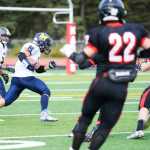 Photo by Kelly Sullivan/ Peninsula Clarion The Kenai Kardinals' Draiden McMinn races to intercept Homer Mariner's Michael players, Saturday, September 27, 2014, at Kenai Central High School in Kenai, Alaska.