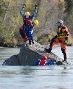 Photo by Rashah McChesney/Peninsula Clarion  Jessica Roper jumps off of Eagle Rock Friday September 27, 2014 as emergency personnel swam in the Kenai River for swift water boat training during the 2014 Alaska Fire Conference on the Kenai Peninsula.