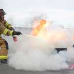 Photo by Rashah McChesney/Peninsula Clarion Two firefighters relax between competitions as the the 2014 Alaska Fire Conference ended with a firefighters skills competition Saturday September 27, 2014 at the Kenai Airport.