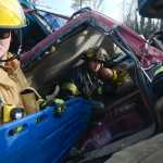 Photo by Rashah McChesney/Peninsula Clarion   (left) Elena Fernandez, a firefighter with the Cordova Volunteer Fire Department races to get her gear on faster than Nikiski Fire Department firefighter Holly Behrens during a skills competition Saturday September 27, 2014 in Kenai, Alaska.