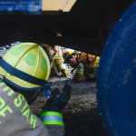 Photo by Rashah McChesney/Peninsula Clarion  Alyeska Fire Department firefighter Matt Smelcer races with Sitka Fire Department firefighter Nick McGraw during a firefighter skills competition Saturday September 27, 2014 in Kenai, Alaska. The competition marked the end of the 2014 Alaska Fire Conference.
