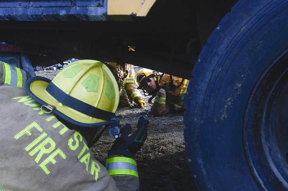 Photo by Rashah McChesney/Peninsula Clarion  Alyeska Fire Department firefighter Matt Smelcer races with Sitka Fire Department firefighter Nick McGraw during a firefighter skills competition Saturday September 27, 2014 in Kenai, Alaska. The competition marked the end of the 2014 Alaska Fire Conference.