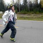 Photo by Rashah McChesney/Peninsula Clarion (left) Chugiak Volunteer Fire and Rescue firefighter Joe Lindquist hands a stretcher to Tell Spragg, firefighter with the Petersburg Fire Department as the two work to pull a mock victim out of a wrecked car Friday September 26, 2014 during the 2014 Alaska Fire Conference. Dozens of firefighters opted for a 2-day extrication training class held at the Reddi Towing and Salvage yard in Kenai, Alaska.