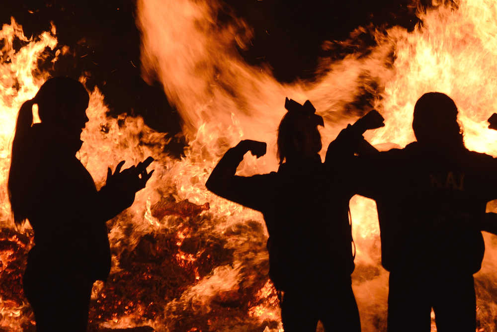 Photo by Rashah McChesney/Peninsula Clarion Students pose for a picture in front of the Kenai Central High School homecoming bonfire Friday Sept. 26, 2014 in Kenai, Alaska.