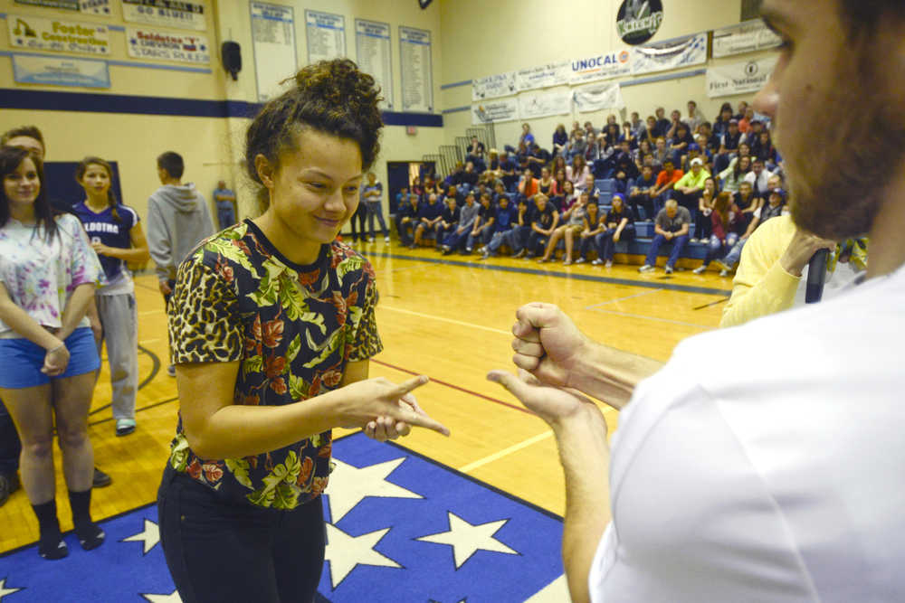 Photo by Rashah McChesney/Peninsula Clarion Lindsey wong, junior, throws "scissors" during a "Rock, Paper, Scissors" game held Sept. 25, 2013 at Soldotna High School during homecoming week in Soldotna, Alaska.