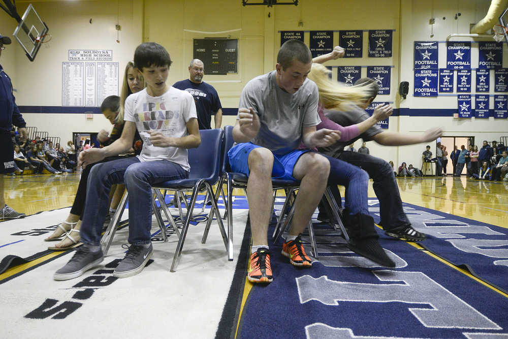 Photo by Rashah McChesney/Peninsula Clarion A game of musical chairs gets rambunctious Thursday Sept. 25, 2013 during homecoming festivities at Soldotna High School in Soldotna, Alaska.