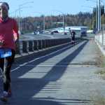DeeDee Jonrowe, of Willow, runs across the David Douthit Veterans Memorial Bridge in Soldotna during the Kenai River Marathon on Sunday. Photo by Kaylee Osowski/Peninsula Clarion