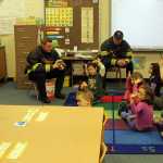 Photo by Dan Balmer/Peninsula Clarion Kenai firefighters Pete Coots, (left) Dustin Voss and Capt. John Harris share fire safety tips with kids Thursday in Mandi Vaala's first grade class at Mountain View Elementary School in Kenai.