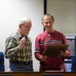Photo by Rashah McChesney/Peninsula Clarion  Kenai Peninsula borough assembly member Bill Smith accepts a plaque from member Brent Johnstone during Smith's last meeting, October 14, 2014 in Soldotna, Alaska.