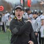 Nikiski head coach Ted Riddall celebrates a fourth-down defensive stop in the first half.  Photo for the Clarion by Michael Dinneen