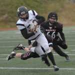 Nikiski's Dylan Broussard (38) eludes a pair of Eielson defenders. Photo for the Clarion by Michael Dinneen