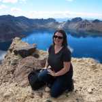 Crouching on a rocky outcropping suspended over the crater lip, visitors to Lake Tianchi in northeast China are encouraged to pose for photographs, especially on clear viewing days.