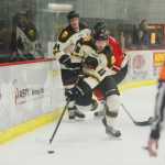 Photo by Kelly Sullivan/ Peninsula Clarion Kenai River Brown Bears' Christopher Usov takes control of the puck behind the goal Friday, October 24, 2014 at the Soldotna Regional Sports Complex in Soldotna, Alaska.