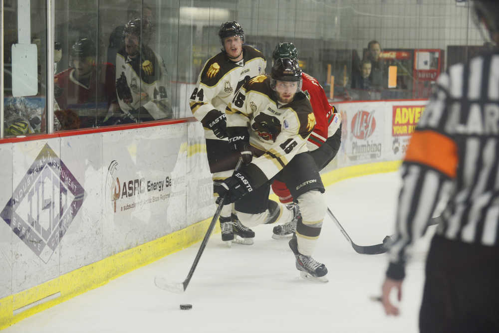 Photo by Kelly Sullivan/ Peninsula Clarion Kenai River Brown Bears' Christopher Usov takes control of the puck behind the goal Friday, October 24, 2014 at the Soldotna Regional Sports Complex in Soldotna, Alaska.
