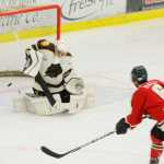 Photo by Kelly Sullivan/ Peninsula Clarion Kenai River Brown Bears' goalie Alec Derks blocks a shot from Minnesota Wilderness Tommy Hall for the puck Friday, October 24, 2014 at the Soldotna Regional Sports Complex in Soldotna, Alaska.