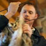 Photo by Rashah McChesney/Peninsula Clarion  Nate Olson, wildlife biologist and pilot for the Kenai National Wildlife Refuge talks about the type of equipment needed to trap a wolf during a class for trappers seeking permits on the refuge Saturday October 25, 2014 in Soldotna, Alaska.