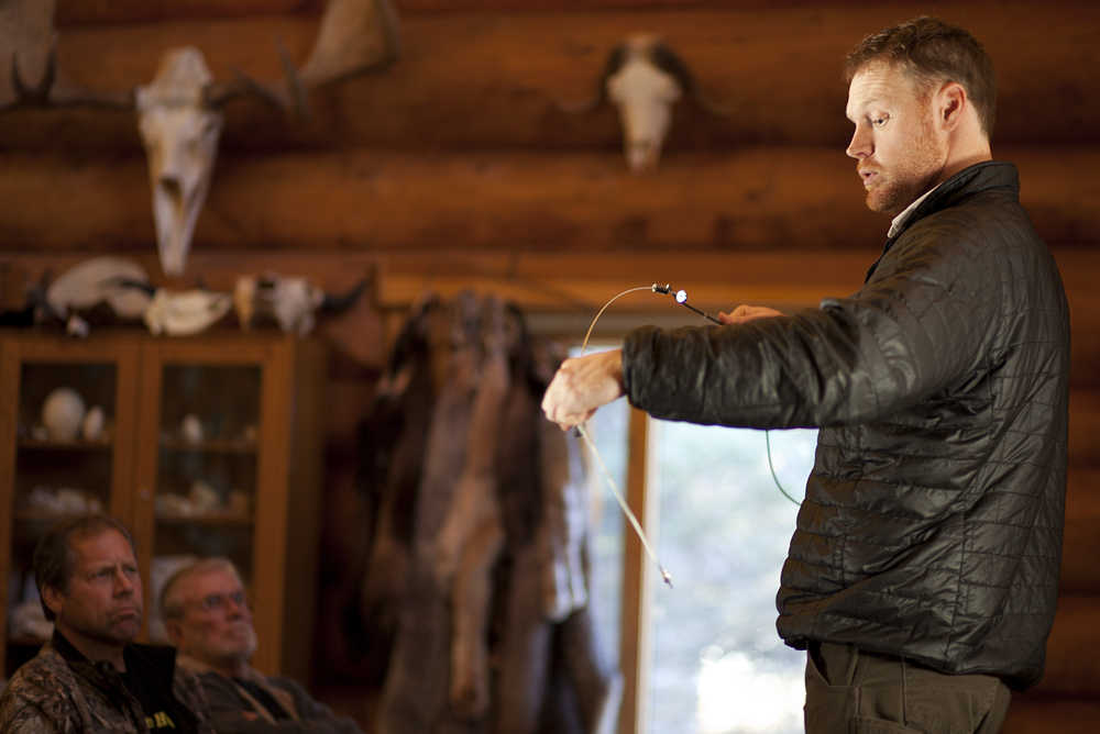 Photo by Rashah McChesney/Peninsula Clarion  Christian de Schweinitz, of Anchorage, talks to a friend about trapping gear during a break from a class on the Kenai National Wildlife Refuge for prospective trappers seeking permits on Saturday October 25, 2014 in Soldotna, Alaska.
