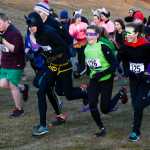 Photo by Rashah McChesney/Peninsula Clarion  Dylan Hogue, 11, pulls ahead of his father Doug Hogue, both of Soldotna, during the Tsalteshi Trails Association's Spook Night Fun Run on Sunday October 26, 2014 in Soldotna, Alaska.