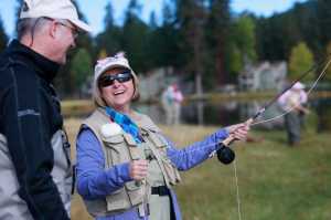 Dale Flick, of Portland, left, helps Carol O'Bryant, of Bend, Ore., practice fly casting during the Casting for Recovery retreat on Oct. 19, 2014 at Black Butte Ranch. The weekend-long retreat focused on fly fishing is for survivors of breast cancer. (AP Photo/The Bulletin, Joe Kline)