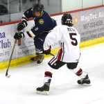Photo by Rashah McChesney/Peninsula Clarion  Homer High School Mariner Anton Kuzmin tries to elude Kenai Central High School Kardinal Levi Mese during their game on Friday Nov. 7, 2014 in Soldotna, Alaska.