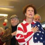 Photo by Dan Balmer/Peninsula Clarion A salute to our veterans Kenai resident Betty Osborn, retired from service in the U.S. Air Force, stands for the signing of "The Star-Spangled Banner" and posting of the colors Monday at the Kenai Senior Center. The community gathered for an evening of remembrance and celebration of veteran's the day before Veteran's Day.