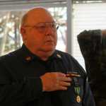 Photo by Dan Balmer/Peninsula Clarion Veterans salute during the singing of the National Anthem at the Veteran's Day ceremony Tuesday, Nov. 11, 2014 at the Soldotna Regional Sports Complex.