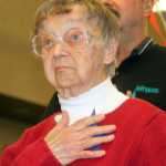 Photo by Dan Balmer/Peninsula Clarion Audience members at the Veteran's Day ceremony Tuesday, Nov. 11, 2014 at the Soldotna Regional Sports Complex place poppies on a field as a symbolic way to honor fallen veterans.
