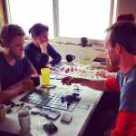 Contributed photo: Donica Nash A Kasilof setnet crew on a break plays Serfs and Soldiers  between picks. (Left)   Wesley Tullis Jr., Delissa Severson, Jonathan Hane , and, Shea Nash.