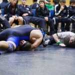 Photo by Kelly Sullivan/ Peninsula Clarion  Nikiski Bulldogs' Willie Olsen in the 285-pound weight class fights being pinned by Soldotna Stars' Dalton Best Saturday, November 15, 2014, at Nikiski High-Middle School in Nikiski, Alaska.