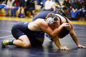 Photo by Kelly Sullivan/ Peninsula Clarion  Nikiski Bulldogs' Luke Johnson in the 220-pound weight class tries to push Soldotna Stars' Taylor Macree's head to the mat Saturday, November 15, 2014, at Nikiski High-Middle School in Nikiski, Alaska.