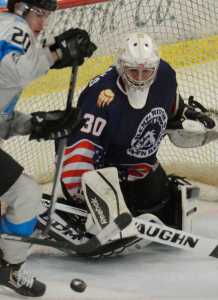 Photo by Kelly Sullivan/ Peninsula Clarion Kenai River Brown Bears' number 30, Alec Derks, blocks a shot by Wenatchee Wild's number 20, Shane Bennett, Friday, Nov. 21, 2014 at the Soldotna Regional Sports Complex in Soldotna, Alaska.