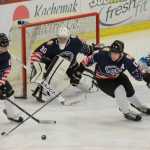 Photo by Kelly Sullivan/ Peninsula Clarion Kenai River Brown Bears' number 30, Alec Derks, watches Bears' number 6, Quiton Wunder, take the puck away from the goal after an unsuccessful shot by the Wenatchee Wild Friday, Nov. 21, 2014 at the Soldotna Regional Sports Complex in Soldotna, Alaska.