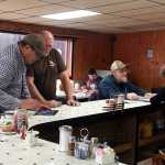 Photo by Dan Balmer/Peninsula Clarion New Sterling restaurant owner Steve Drolet helps a customer pay for his meal using an iPad point of sale system Wednesday, Nov. 19, 2014. The Restaurant at Shea Drolet Cafe next to Otto's Landing on the Sterling Highway, opened up at the beginning of November. Drolet purchased the inn and restaurant from Richard Otto, shortly after moving to Alaska.