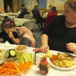 Ben Boettger/Peninsula Clarion PollyAnna Makabe (right) and Rye Cross at the Salvation Army Community Dinner on Thursday, Nov. 27. "We came to the dinner because we just moved down here from Wasilla, and don't know anyone yet," said Cross. "I didn't want to make a Thanksgiving dinner for just two."