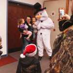Photo by Kelly Sullivan/ Peninsula Clarion Avah, Kenzy and Alyssa Weeks pose for photos with Frosty the Snowman at  Christmas Comes to Kenai November 28, 2014, in at the Kenai Chamber of Commerce and Visitor Center in Kenai, Alaska. Ivan Weeks said it was the first year Avah Weeks would be seeing Santa Claus, but her sister Kenzey Weeks had before.