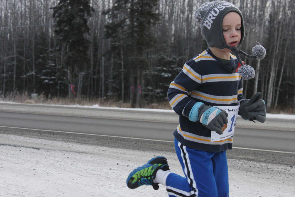 Photo by Kelly Sullivan/ Peninsula Clarion runs on the Unity Trail during the T200 Turkey Trot 5k and 10k Run, Friday, Nov. 28, 2014, at the Soldotna Regional Sports Complex in Soldotna, Alaska. Tsalteshi Trails Association teamed up Tustumena 200 Sled Dog Race for this year's fourth annual event.