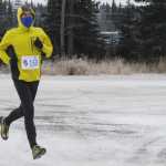 Photo by Kelly Sullivan/ Peninsula Clarion Jamie Nelson sprinted to the finish after running the Unity Trail for the T200 Turkey Trot 5k and 10k Run, Friday, Nov. 28, 2014, at the Soldotna Regional Sports Complex in Soldotna, Alaska. Tsalteshi Trails Association teamed up Tustumena 200 Sled Dog Race for this year's fourth annual event.