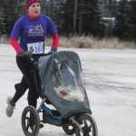 Photo by Kelly Sullivan/ Peninsula Clarion Annaleah Karren pushed her daughter Emma and son Robert on the Unity Trail during the T200 Turkey Trot 5k and 10k Run, Friday, Nov. 28, 2014, at the Soldotna Regional Sports Complex in Soldotna, Alaska. Tsalteshi Trails Association teamed up Tustumena 200 Sled Dog Race for this year's fourth annual event.